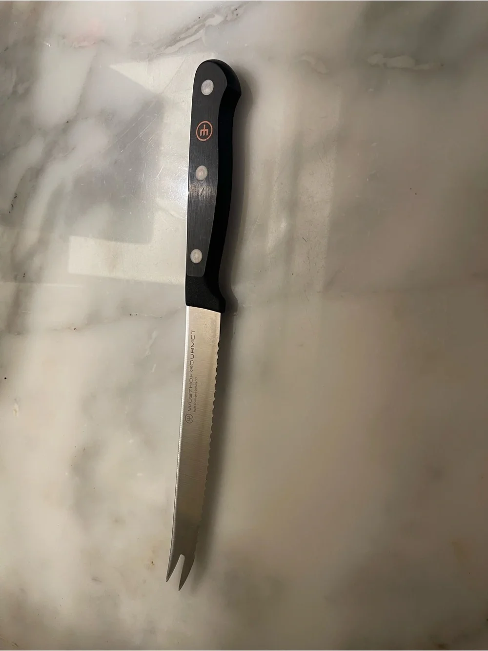 Wusthof Serrated Kitchen Knife with Black Handle and Silver Blade.
